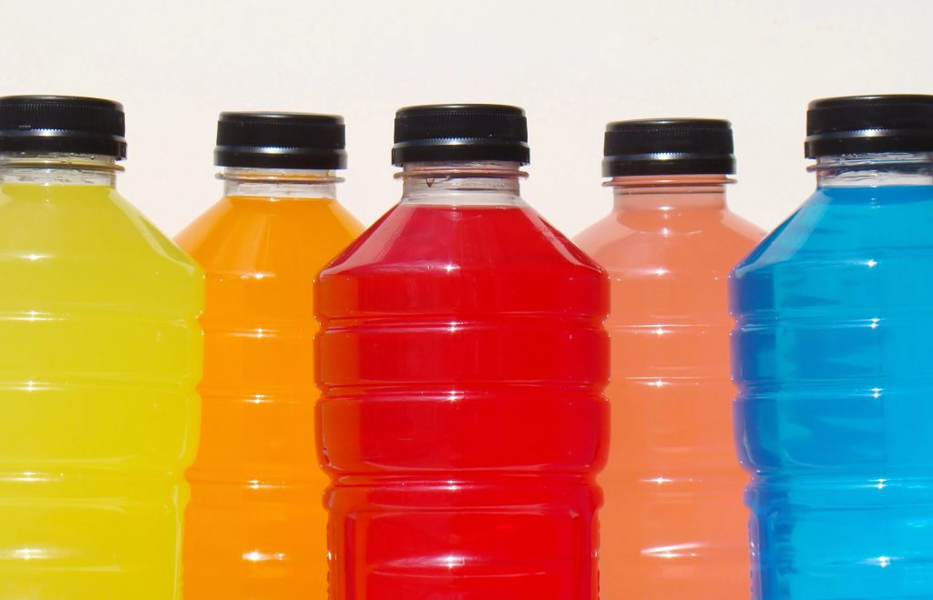 Close up of various sugary sports drinks.